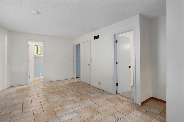 empty room with a textured ceiling