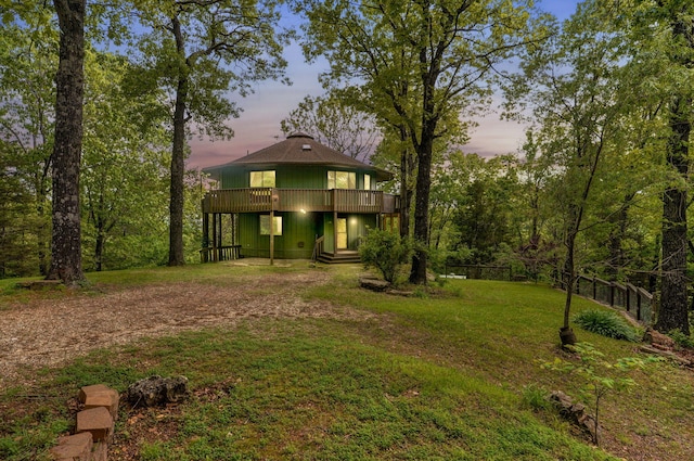 view of front of house featuring dirt driveway and a wooden deck