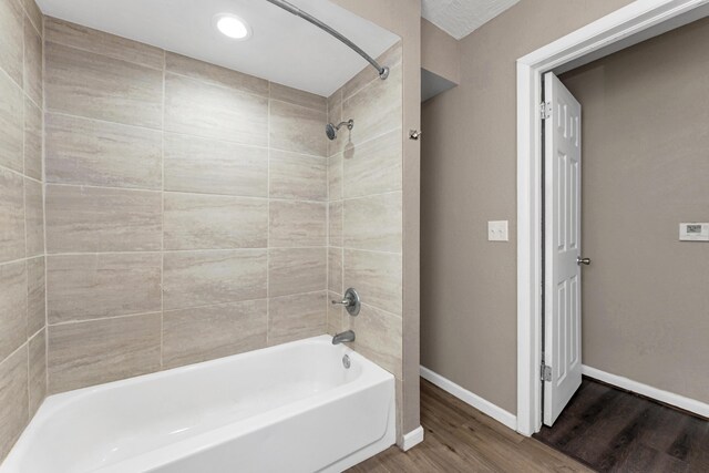 1606 N Waverly Ave, Springfield, MO 65803 - bathroom featuring baseboards, wood finished floors, tub / shower combination, and recessed lighting