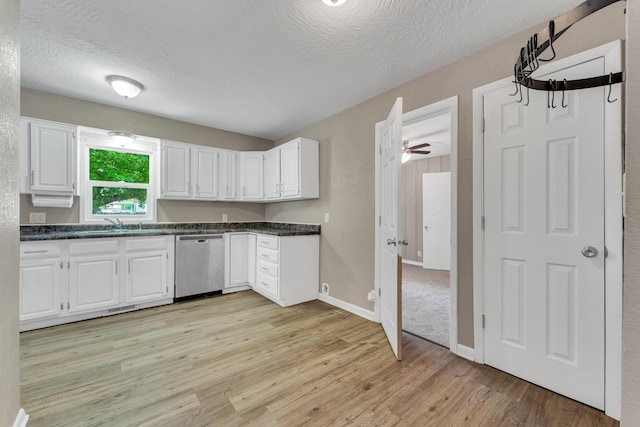 1606 N Waverly Ave, Springfield, MO 65803 - kitchen featuring dishwasher, dark countertops, light wood-style floors, white cabinets, and a textured ceiling