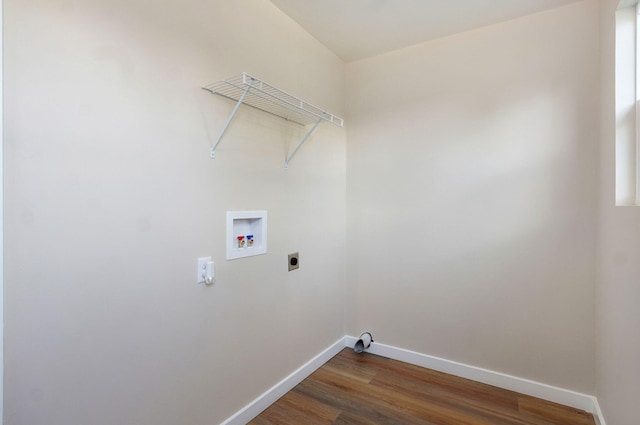 washroom with hookup for an electric dryer, baseboards, washer hookup, and dark wood-style floors
