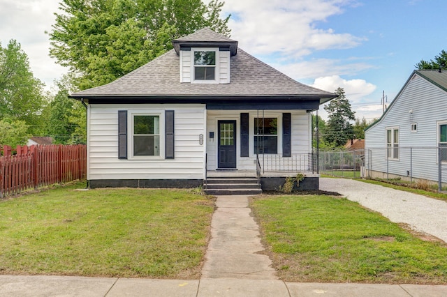 bungalow-style house with a porch, a shingled roof, and gravel driveway