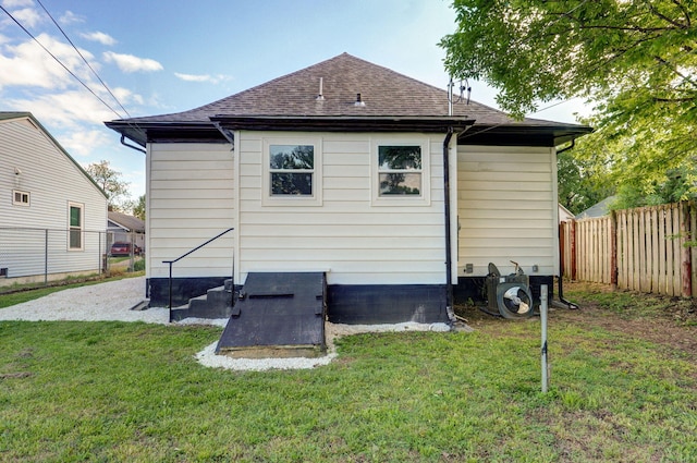 rear view of property featuring roof with shingles