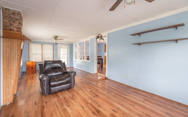 living area featuring a ceiling fan and wood finished floors