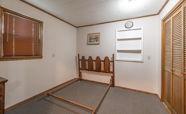 interior space with ornamental molding and baseboards