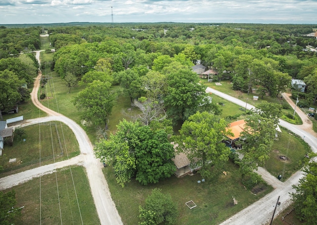 view of property location with a forest