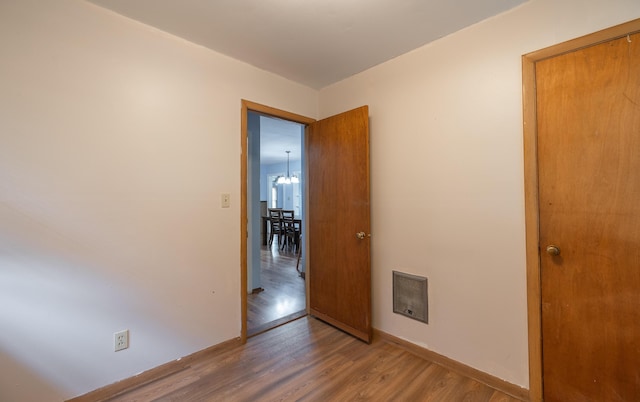 unfurnished room featuring wood finished floors and baseboards