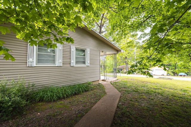 view of property exterior with a yard