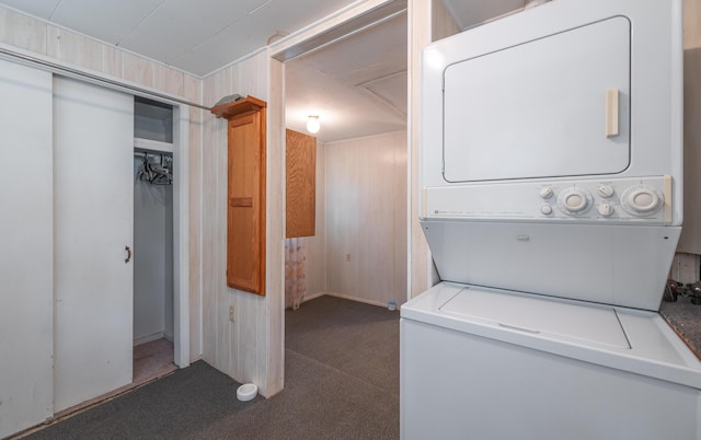 laundry area with stacked washing machine and dryer and carpet