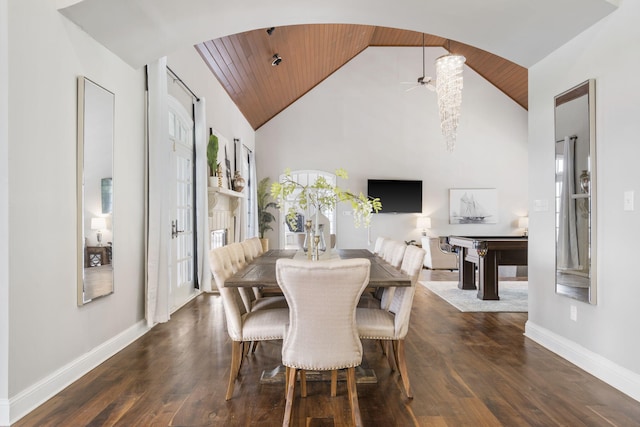 dining room with high vaulted ceiling, wood ceiling, baseboards, dark wood-style floors, and arched walkways