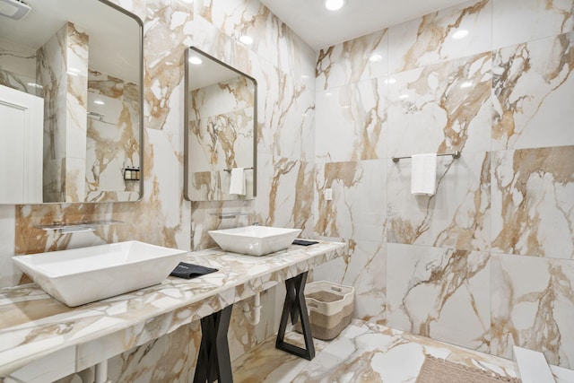 bathroom featuring tile walls, marble tiled flooring, and recessed lighting