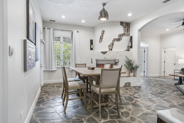 dining area with stone flooring, baseboards, arched walkways, a ceiling fan, and recessed lighting