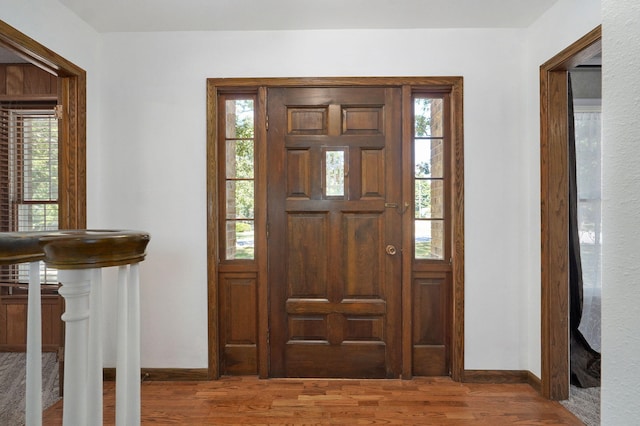 entrance foyer with wood finished floors and baseboards