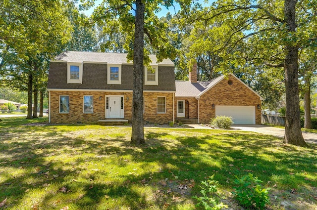 view of front of house featuring a garage, a chimney, concrete driveway, and brick siding