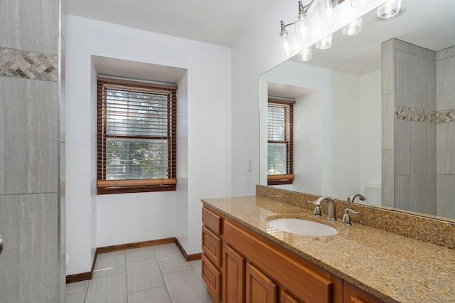 full bathroom with vanity, baseboards, and tile patterned floors