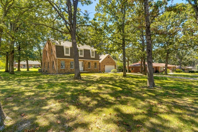 colonial inspired home featuring stone siding, a front lawn, and a garage