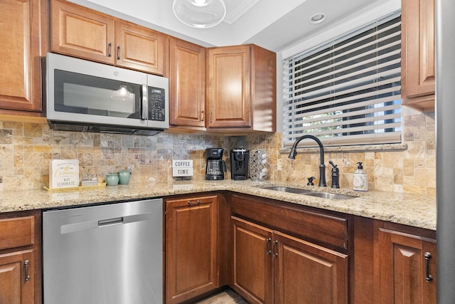 112 Overlook Dr Unit 5, Branson, MO 65616 - kitchen featuring stainless steel appliances, a sink, decorative backsplash, and light stone countertops