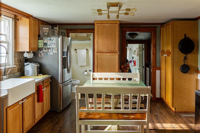 111 W Olive St, El Dorado Springs, MO 64744 - kitchen with dark wood finished floors, tasteful backsplash, light countertops, and stainless steel fridge with ice dispenser