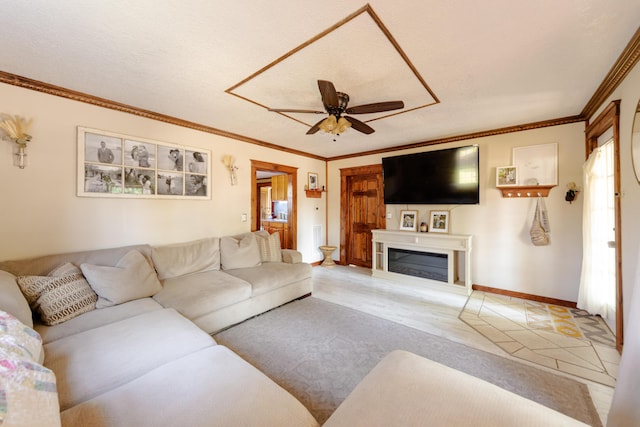 111 W Olive St, El Dorado Springs, MO 64744 - carpeted living area featuring a ceiling fan, ornamental molding, a glass covered fireplace, and baseboards