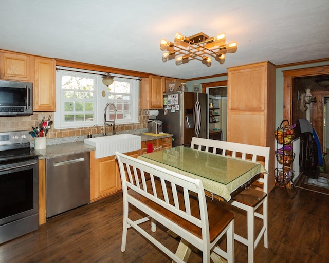 111 W Olive St, El Dorado Springs, MO 64744 - kitchen featuring appliances with stainless steel finishes, a sink, dark wood finished floors, and backsplash