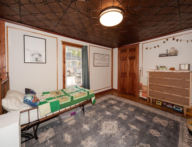 111 W Olive St, El Dorado Springs, MO 64744 - bedroom featuring an ornate ceiling and wood finished floors
