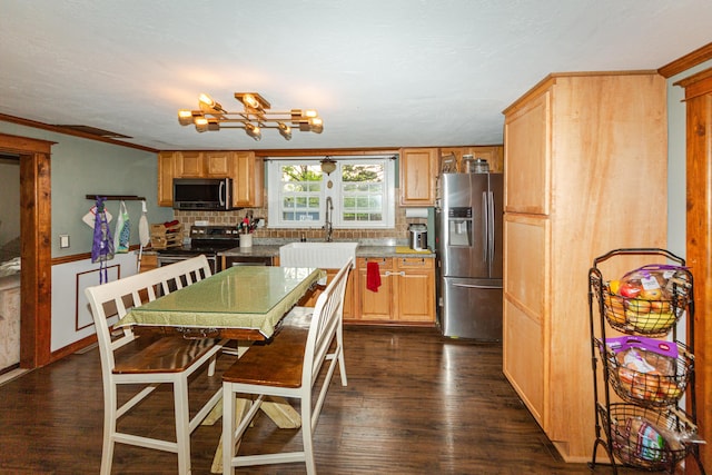 111 W Olive St, El Dorado Springs, MO 64744 - kitchen featuring stainless steel appliances, tasteful backsplash, a chandelier, dark wood-style flooring, and crown molding