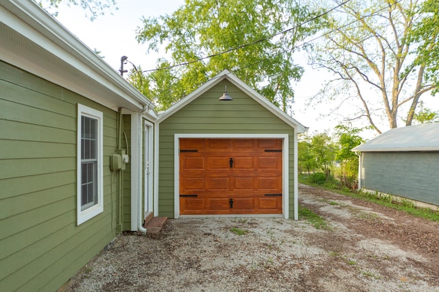 111 W Olive St, El Dorado Springs, MO 64744 - detached garage with dirt driveway