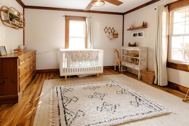 111 W Olive St, El Dorado Springs, MO 64744 - bedroom featuring crown molding, baseboards, and light wood finished floors