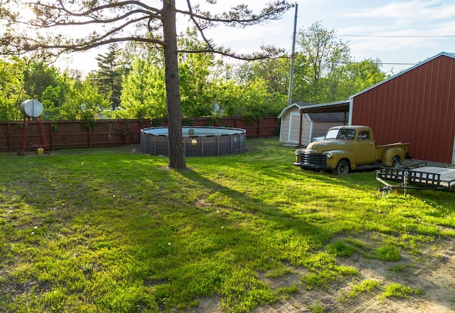 111 W Olive St, El Dorado Springs, MO 64744 - view of yard featuring an outbuilding and a storage unit