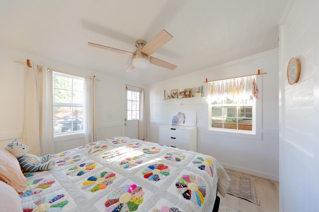 111 W Olive St, El Dorado Springs, MO 64744 - bedroom featuring ceiling fan and wood finished floors