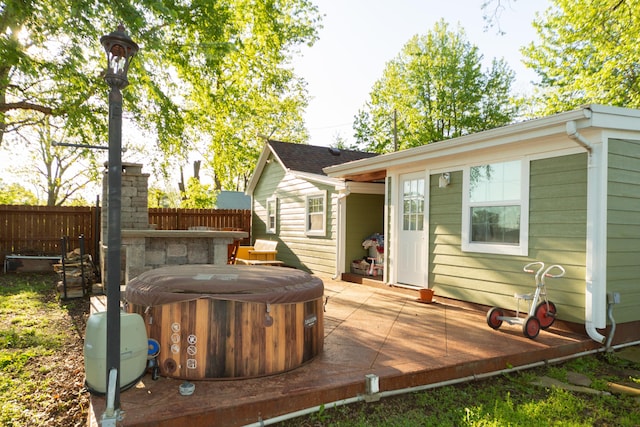 111 W Olive St, El Dorado Springs, MO 64744 - wooden terrace featuring a hot tub and fence