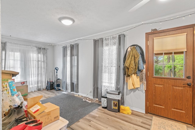 entryway with wood finished floors and a textured ceiling