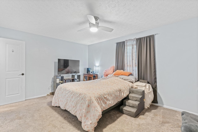 carpeted bedroom featuring baseboards, ceiling fan, and a textured ceiling