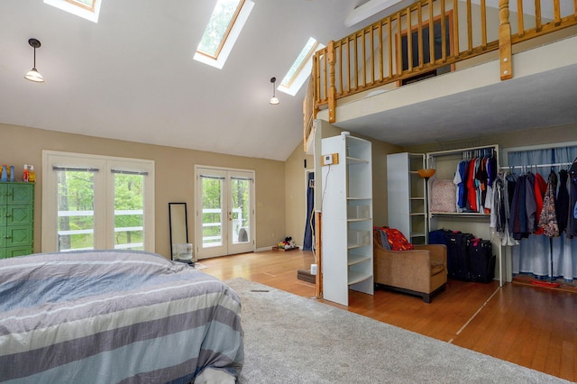4855 E Cimarron Ln, Springfield, MO 65803 - bedroom featuring french doors, wood finished floors, high vaulted ceiling, a skylight, and access to exterior