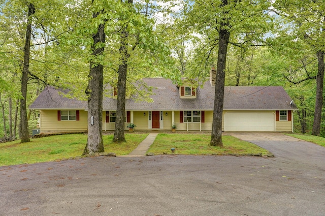 4855 E Cimarron Ln, Springfield, MO 65803 - view of front facade featuring asphalt driveway, covered porch, an attached garage, and a shingled roof