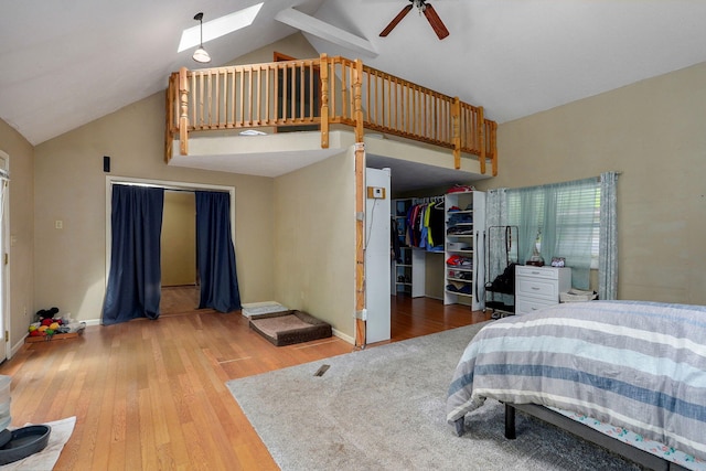 4855 E Cimarron Ln, Springfield, MO 65803 - bedroom featuring a skylight, light wood-style flooring, baseboards, and high vaulted ceiling