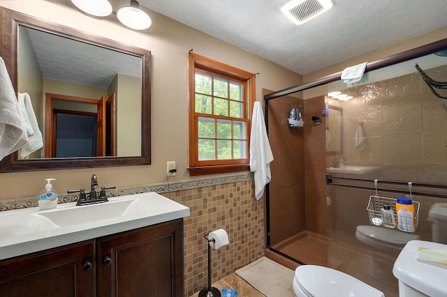 4855 E Cimarron Ln, Springfield, MO 65803 - bathroom featuring tile walls, toilet, a stall shower, a wainscoted wall, and vanity
