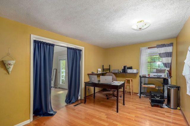 4855 E Cimarron Ln, Springfield, MO 65803 - office space with wood finished floors, healthy amount of natural light, a textured ceiling, and baseboards
