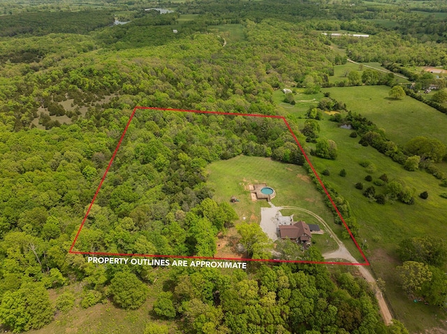 view of property location with a heavily wooded area and property boundaries highlighted