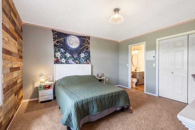 2885 Possum Trot Rd, Billings, MO 65610 - carpeted bedroom featuring a closet, wood walls, baseboards, connected bathroom, and a sink