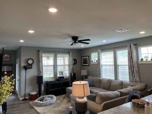 living room with wood finished floors, baseboards, a ceiling fan, and recessed lighting