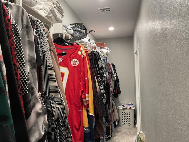 walk in closet featuring carpet