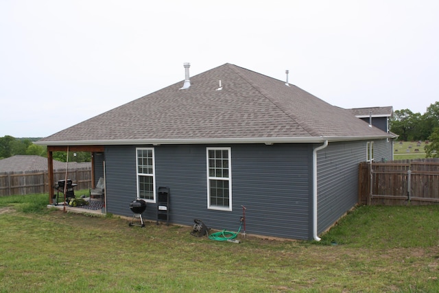 rear view of property with a shingled roof
