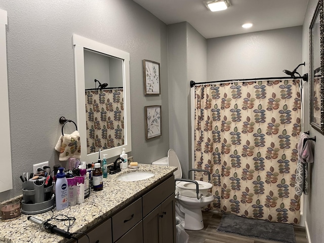 bathroom with wood finished floors, toilet, a shower with curtain, and vanity