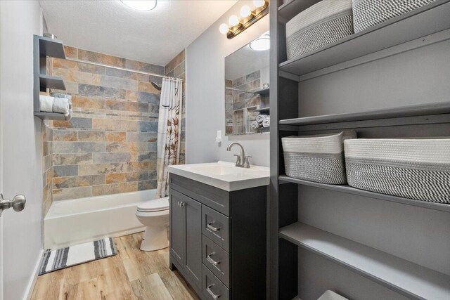 79 County Road 101, Gainesville, MO 65655 - bathroom featuring wood finished floors, toilet, shower / tub combo with curtain, and vanity