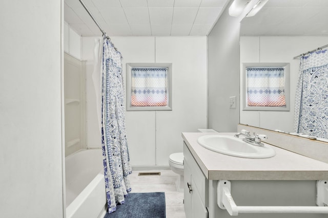 bathroom with toilet, vanity, shower / bath combination with curtain, and tile patterned floors