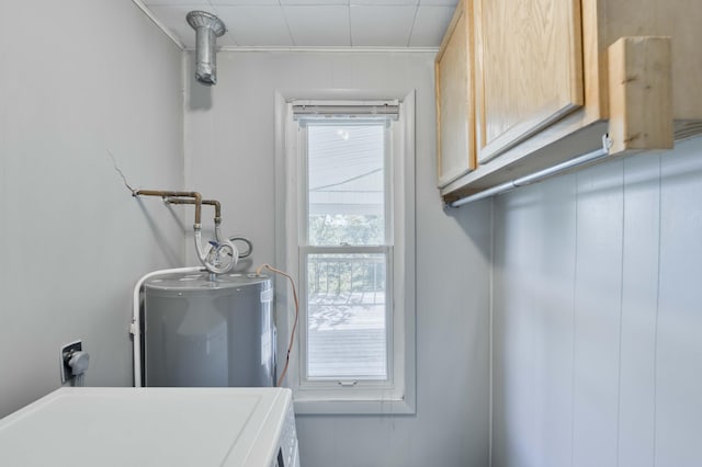 laundry area with washer / clothes dryer, water heater, cabinet space, and crown molding
