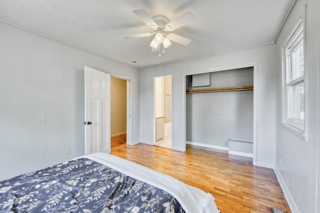 bedroom featuring light wood-type flooring, a closet, and baseboards
