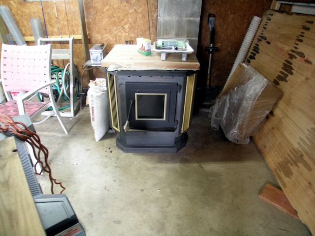 detailed view of a wood stove and unfinished concrete floors