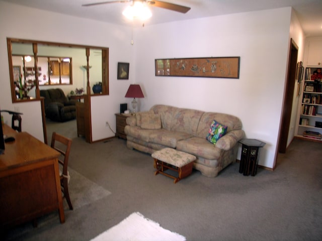 living area featuring carpet flooring and ceiling fan
